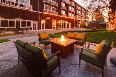 Outdoor patio seating with fire pit at dusk