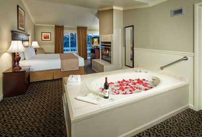 King bed with fire place and whirpool tub with rose petals